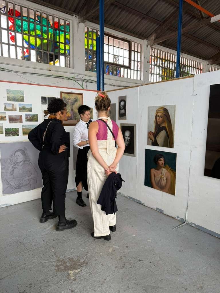 Visitors engaging with artwork at Barcelona Academy of Art graduate's open studio